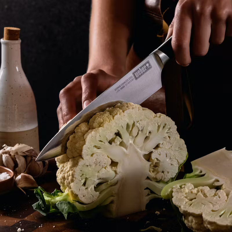 Chefs Knife 3 German steel cold forged Chefs knife cutting through cabbage.