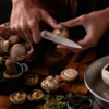 German steel cold forged Utility Knife cutting up mushrooms.