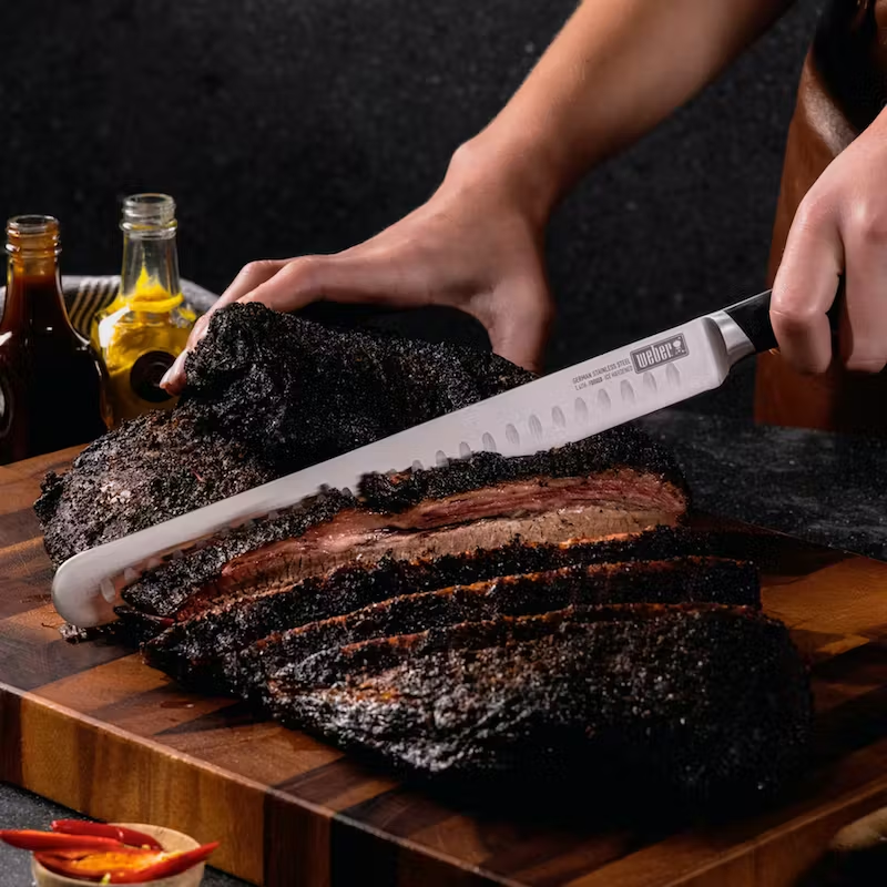 German steel cold forged Slicing knife carving a brisket.