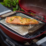 Weber Q N Smoker Box 2 Weber Smoker Box in use while cooking a salmon fillet.